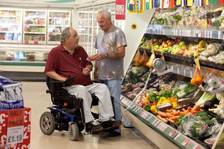 Disabled man in supermarket with his live-in carer