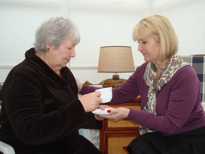 Live-in carer helping lady