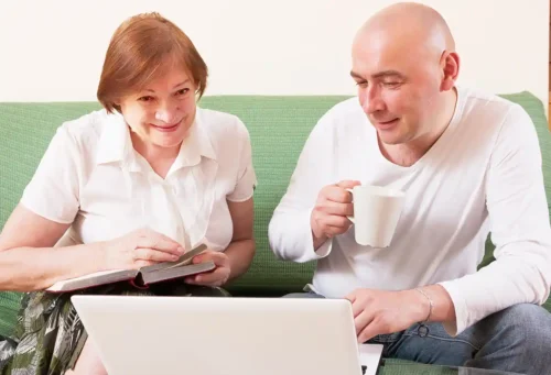 Mother and son looking at costs of live-in care.