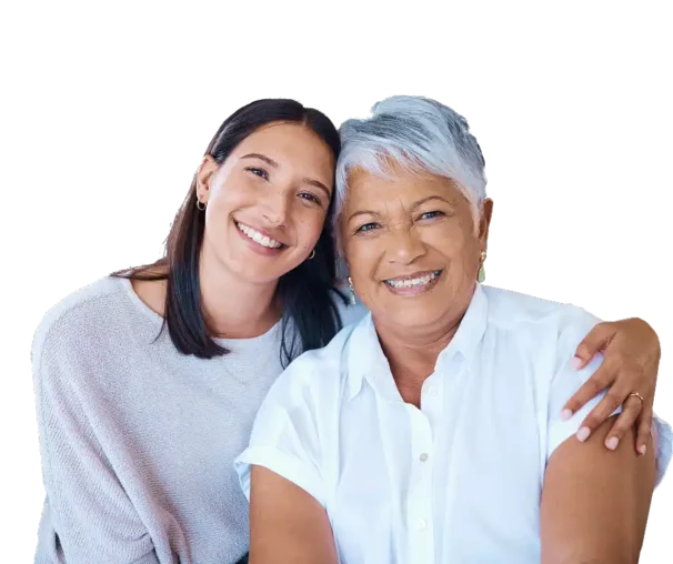 Smiling carer with her arm around a happy elderly lady, representing compassionate live-in care and support at home.