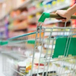 Person pushing a supermarket shopping trolley during quiet hours
